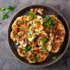 cauliflower steaks with herb sauce and spice. plant based meat substitute