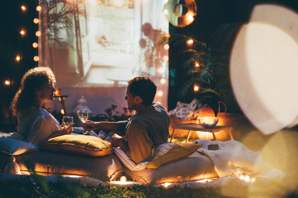 Couple watches movies at the backyard.